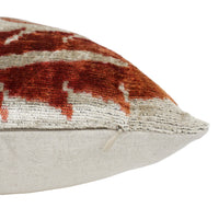 Close-up of an orange and cream patterned pillow.