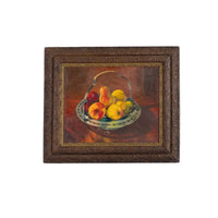 Framed painting of a still life with fruits on a white background