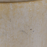 A close-up of a textured, warm beige ceramic surface with subtle speckles and minor scuffs.