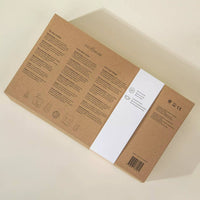 Cardboard box with text and a white label on a beige background