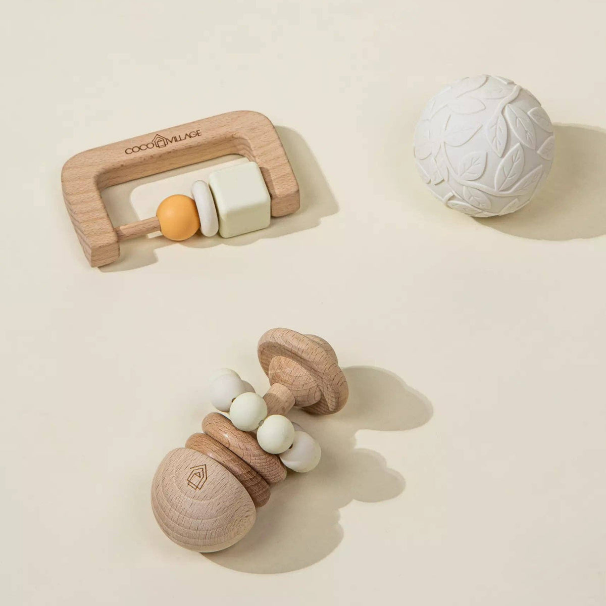 Wooden baby teething toys on a beige background