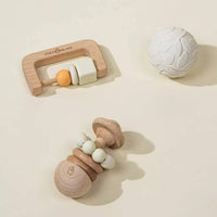 Wooden baby teething toys on a beige background