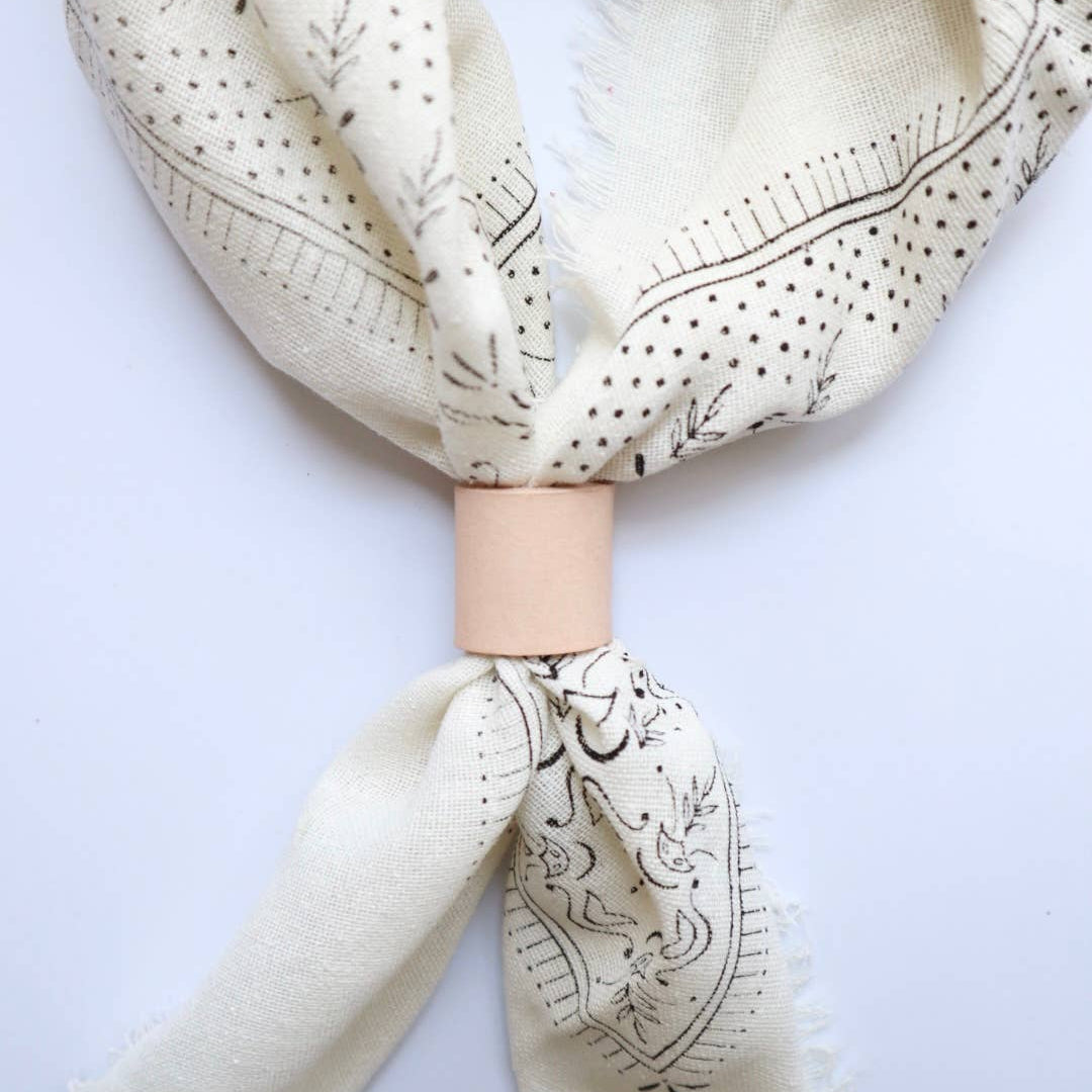 Beige scarf with black patterns on a white background