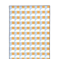 A rectangular woven textile with a geometric checkerboard pattern in light blue, white, and mustard yellow, featuring a small white label near the bottom right.