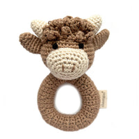 Crocheted toy with a ring and bull design on a white background
