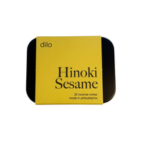 A square tin of Dilo Hinoki Sesame incense cones, featuring a bright yellow label with black text and a black metal tin visible on the sides, set against a plain white background.