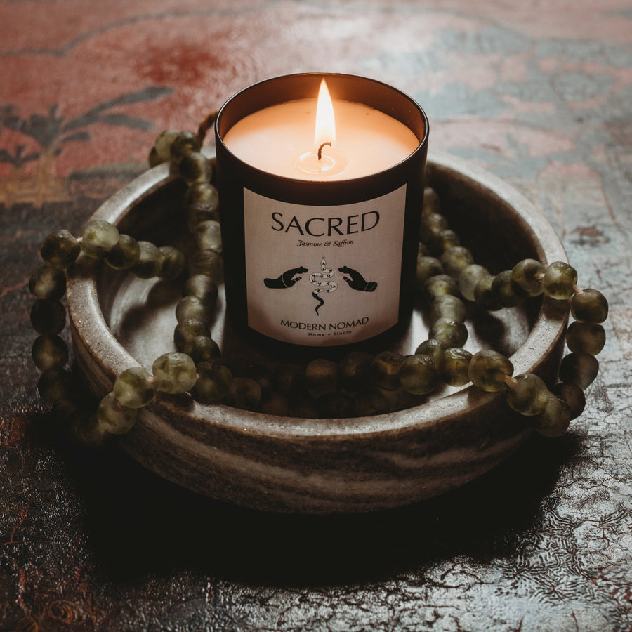 Sacred candle in bowl with beads