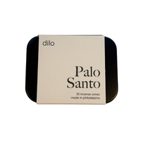 A square metal tin of Dilo Palo Santo incense cones, featuring a cream-colored paper label with black text, set against a plain white background.