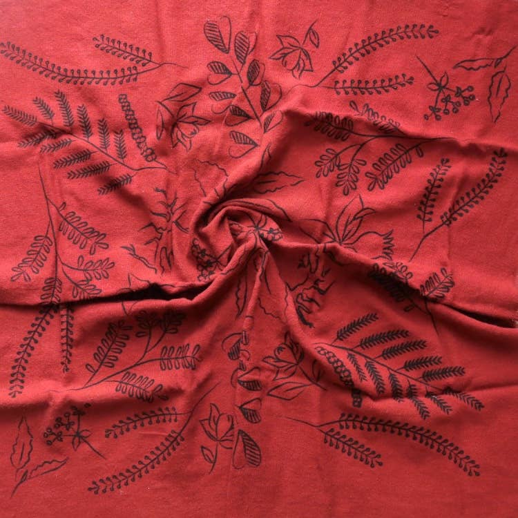 Red fabric with black floral patterns