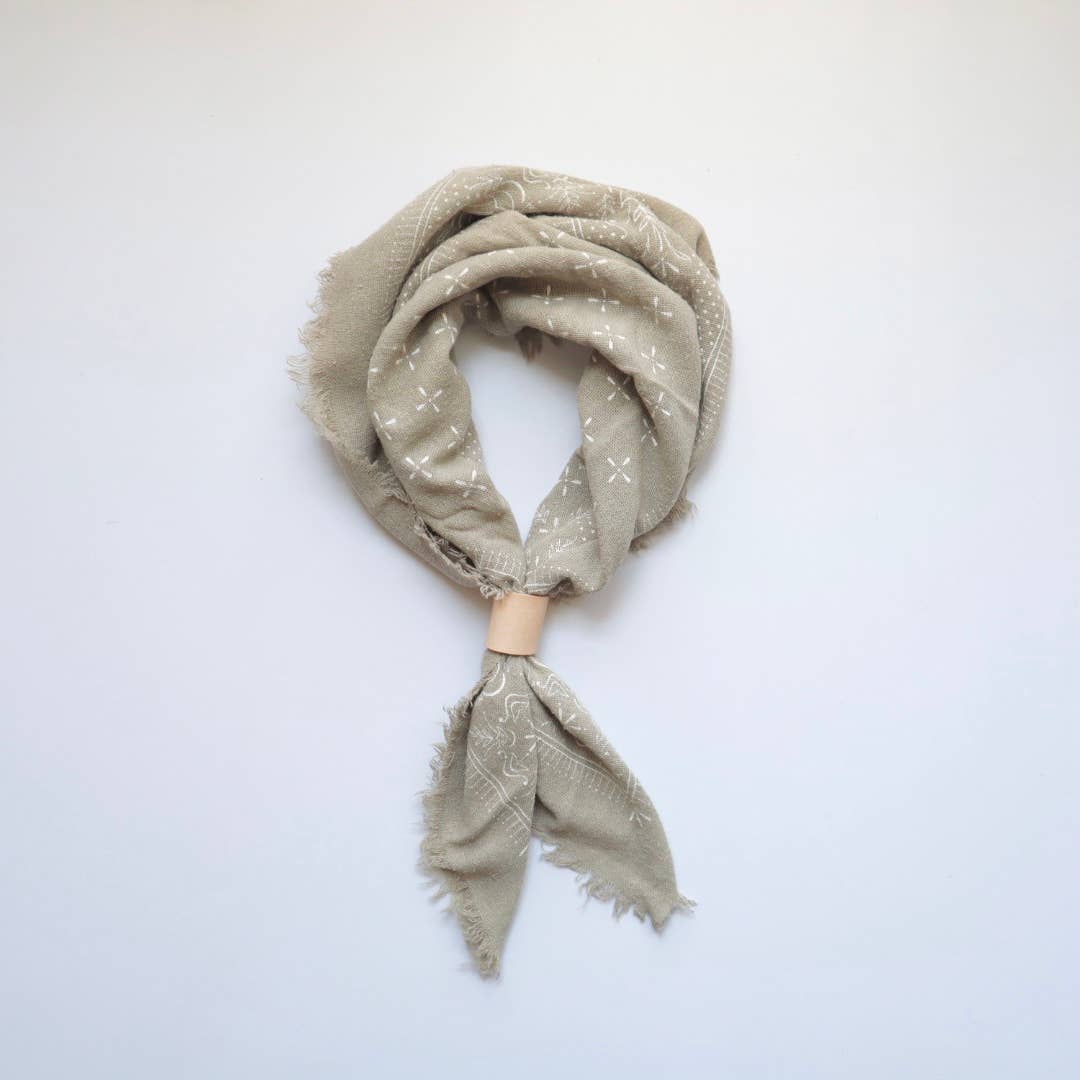Beige scarf with subtle pattern on a white background