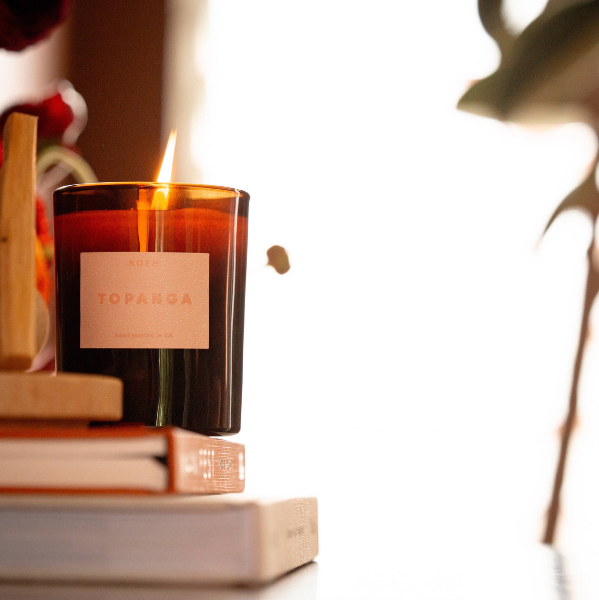 Topanga candle on books with a blurred background