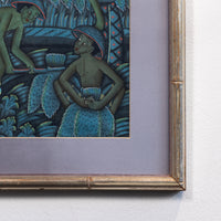 A framed art print featuring a stylized illustration of figures in a blue and green jungle-like scene, mounted on a light gray wall.