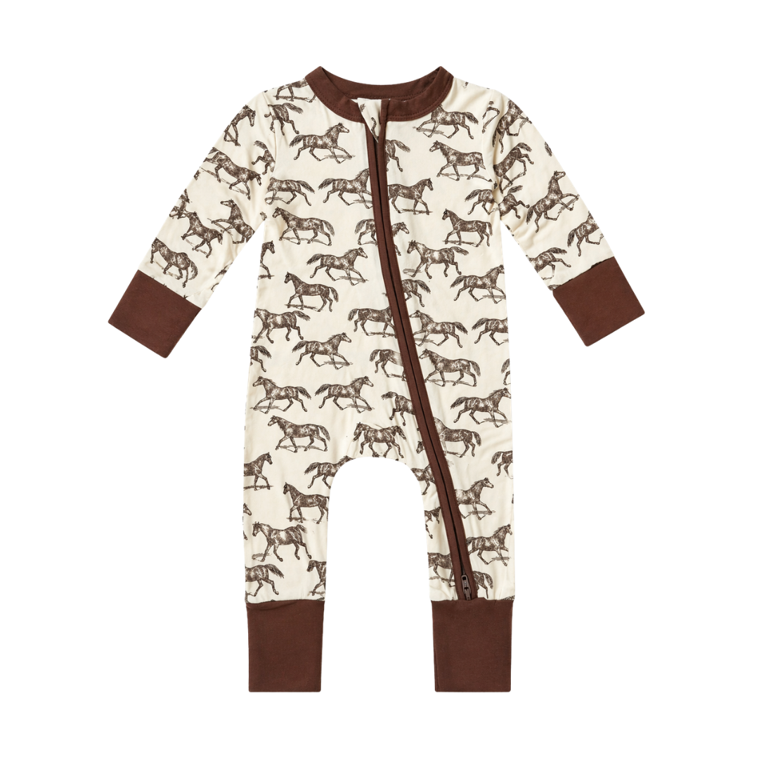 A baby long-sleeve footless one-piece sleeper with a brown horse print on an off-white background, featuring solid brown cuffs and hem, and a front zipper.
