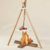 Wooden teepee-like structure with shelves and a small fire on a beige background