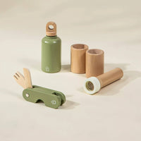 Set of green and brown children's toys on a beige background