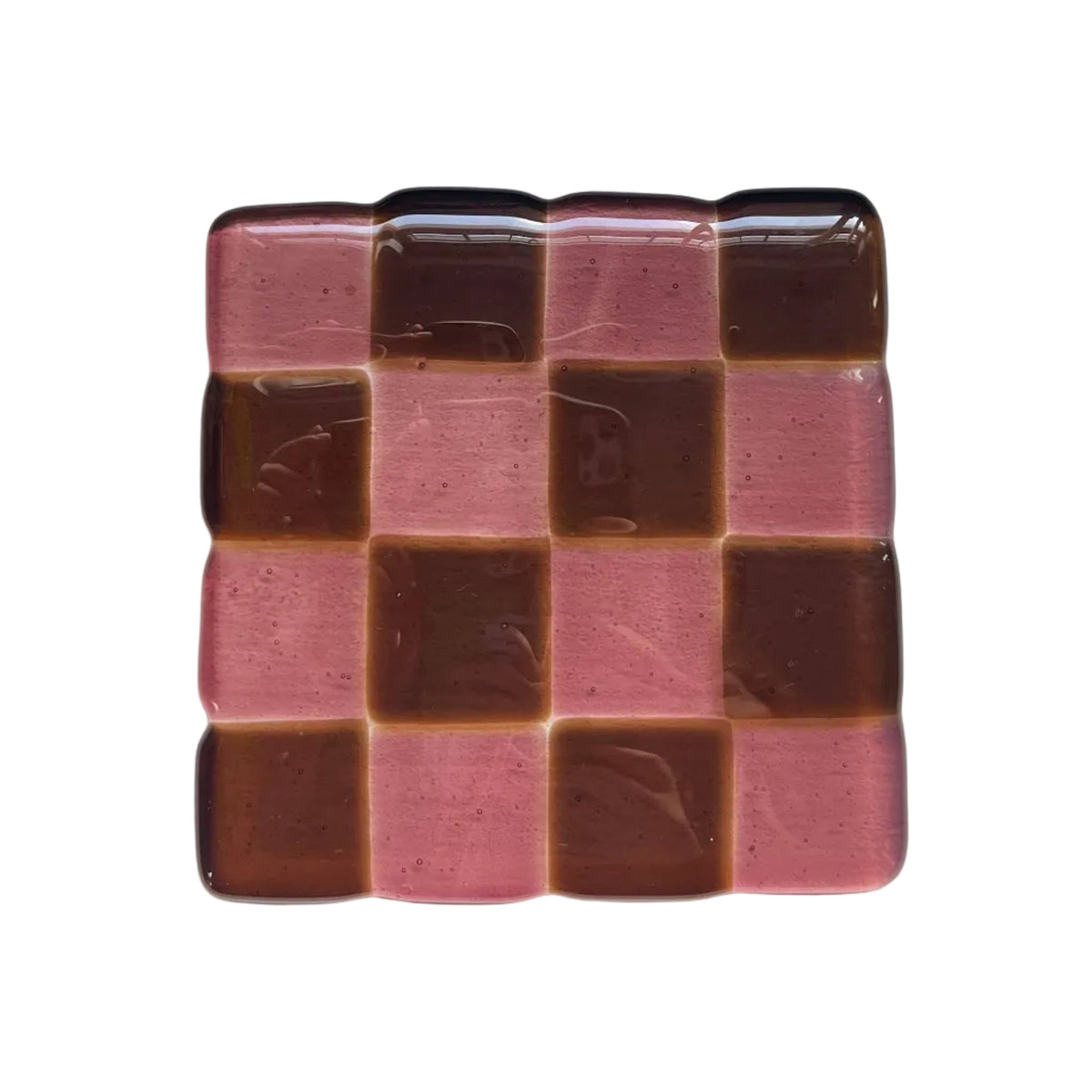 Glass coaster with checkered pattern on a white surface with decorative items.