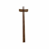 Wooden chopsticks and wooden rest on a white surface