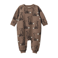 Brown baby onesie with fox pattern on a black background
