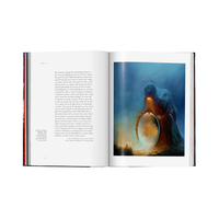 An open book showing a printed text page on the left and a large fantasy artwork on the right, photographed against a plain white background.