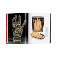 Open book showing images of a glass hand, wooden device, and other objects on a white background.