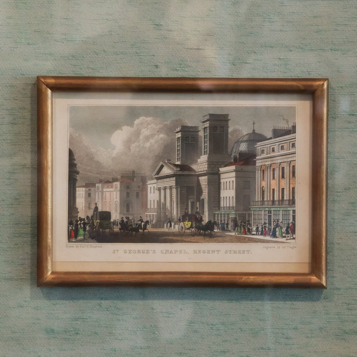 close up of historic art print framed on blue raw silk matting