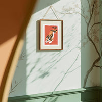 Framed artwork of a tiger on a wall with sunlight casting shadows.