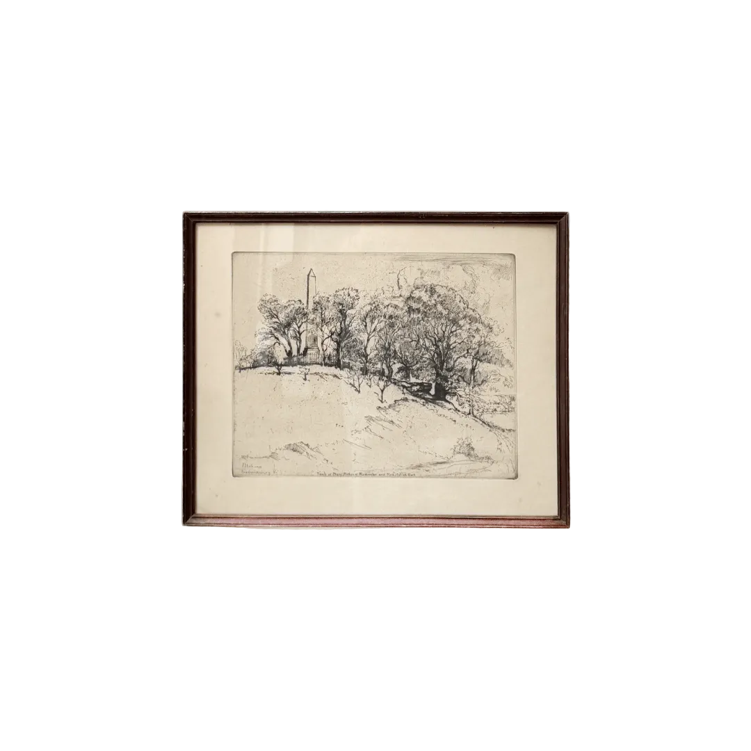 Framed black and white landscape drawing on a white wall