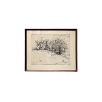 Framed black and white landscape drawing on a white wall