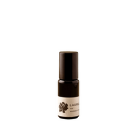 Small brown bottle with a white label on a green background
