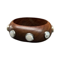 Wooden bracelet with silver and pearl accents on a white background